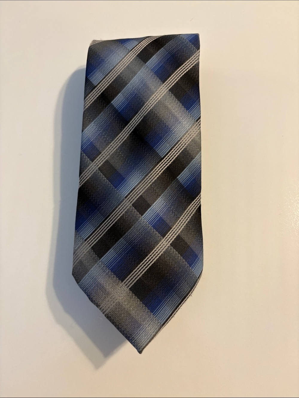 Blue, grey, and black tie. 100% polyester.